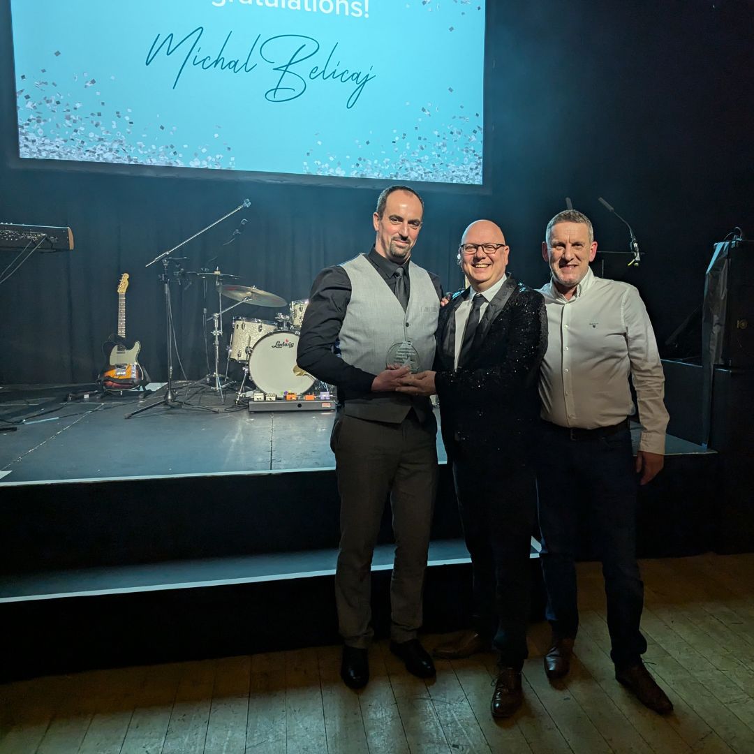 Michael Belicaj receiving his award with Jon Marlow and Paul Farrow Michael Belicaj receiving his award with Jon Marlow and Paul Farrow