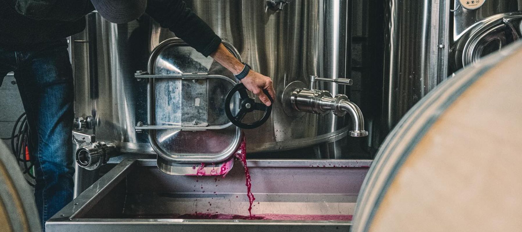 Flint Vineyard red wine being poured from a tank Flint Vineyard red wine being poured from a tank